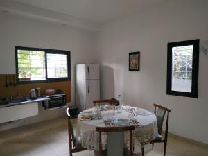 a kitchen with a table with chairs and a refrigerator at Departamentos La Rinconada in Yerba Buena