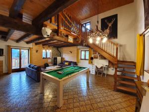 a living room with a pool table and stairs at LE CHALET VOSGIEN bain nordique Kota Grill in Gérardmer