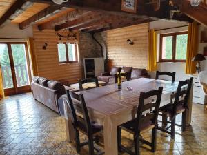 a dining room with a large table and chairs at LE CHALET VOSGIEN bain nordique Kota Grill in Gérardmer