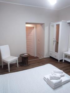 a bedroom with a bed and a chair and a table at Glam Resort Giulia in La Spezia
