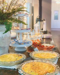 a table topped with pies and plates of food at The Respite B&B in Paducah