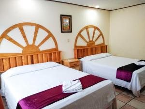 Un ou plusieurs lits dans un hébergement de l'établissement Hotel Esmeralda