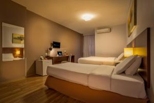 Postel nebo postele na pokoji v ubytování H3 Hotel Paulista