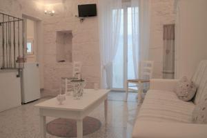 Biały salon z białą kanapą i stołem w obiekcie Casa Filomena w mieście Ostuni +37 zdjęć