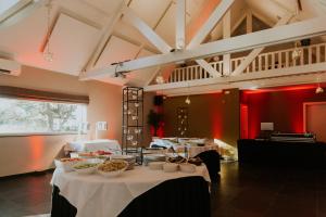 a dining room with tables with food on them at Guesthouse De Casteleer in Kasterlee