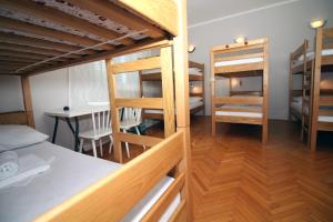 a dorm room with bunk beds and a table at Hostel Marko in Tisno