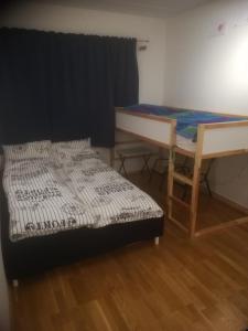 a bed and a table in a room at Sjønær leilighet med gangavstand til strand i Larvik in Larvik