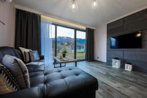 Televízia a/alebo spoločenská miestnosť v ubytovaní Apartament Marron