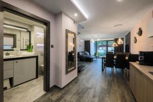a kitchen and living room with a table and chairs at Apartament Marron in Szczyrk