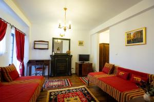 a living room with two couches and a television at Complex Turistic "Moara Dragaicilor" in Buzau