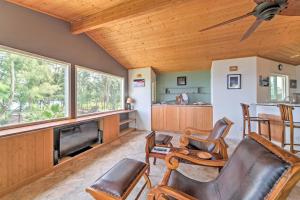 a living room with a couch and chairs and a fireplace at Direct Oceanfront, Big Island Vacation Rental Home in Keaau