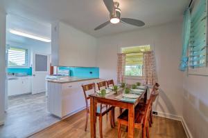 a kitchen and dining room with a table and chairs at Charming Historic Hilo House Minutes to Beach! in Hilo