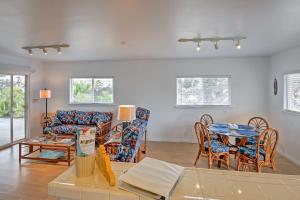 a living room with a couch and a table and chairs at Ocean View Bungalow with Lanai 13 Mi to South Point in Hawaiian Ocean View