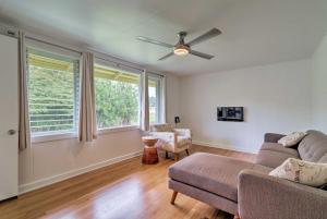 a living room with a couch and a ceiling fan at Charming Historic Hilo House Minutes to Beach! in Hilo