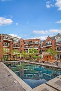 an apartment complex with a pool in front of a building at The Aspen Mountain Residences in Aspen