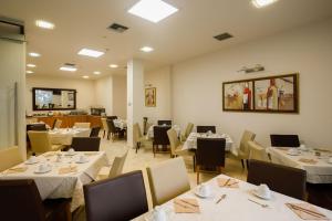 a dining room with white tables and chairs at Hotel Athina in Lamía