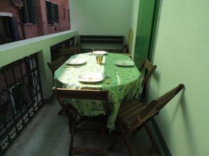 a table with a green table cloth on a balcony at Biennale Appartamento grande in Venice