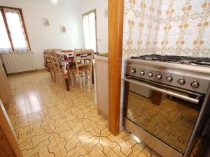 a kitchen with a stove and a dining room with a table at "Al Castello" Biennale - Venezia in Venice