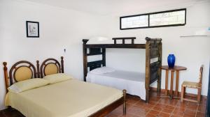 Postel nebo postele na pokoji v ubytování Hostal Dumbira