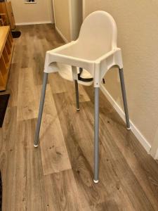 a white chair sitting on top of a wooden floor at Moderne Appartement Hannover Centrum - City Flat HbF in Hannover