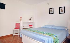 Postel nebo postele na pokoji v ubytování Hostal Dumbira