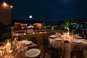 a set of tables with candles on a patio at night at Autentico Monterrey in Monterrey