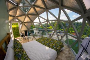 a large room with a bed in a glass dome at Eco Domo glamping in Armenia