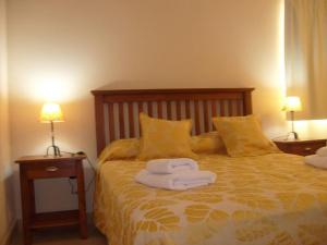 מיטה או מיטות בחדר ב-Complejo Antares