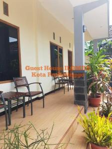 a building with chairs and tables on a patio at iLOMBA in Probolinggo