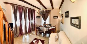 a living room with a couch and a dining room at Ermones Diamond Villa in Vátos