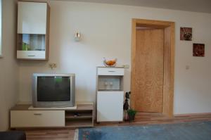 a living room with a television and a door at Apart Patricia in Längenfeld