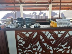 a table with cups and drinks on top at Sea Star Resort Semporna in Semporna