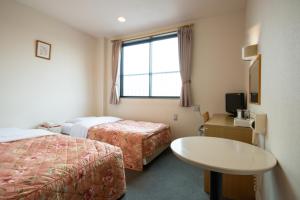 Llit o llits en una habitació de Hotel Hana