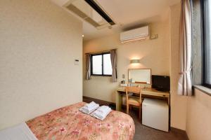 Llit o llits en una habitació de Hotel Hana