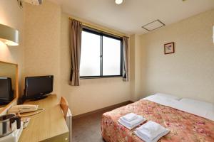 Llit o llits en una habitació de Hotel Hana
