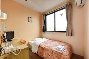 Llit o llits en una habitació de Hotel Hana