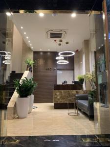 a lobby with a waiting area with plants in it at Hadiva Boutique Hotel in Da Nang