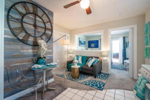 a living room with a couch and a table at 10 STEPS TO THE BEACH COUPLES RETREAT in Clearwater Beach
