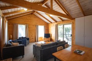 a living room with couches and a table at Beauty Point Tourist Park in Beauty Point