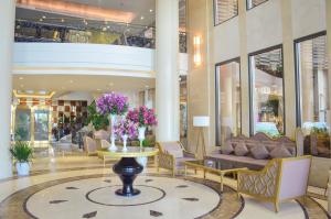a lobby with a couch and a table in a building at Holiday Beach Hotel Danang in Da Nang +114 photos