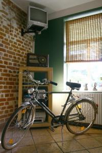 a bike parked in a room with a television at Otrā Elpa in Valka +7 photos