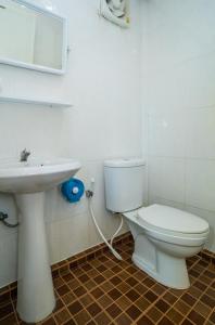 a bathroom with a white toilet and a sink at Hill Zone Home Stay by Little Paradise in Haad Rin
