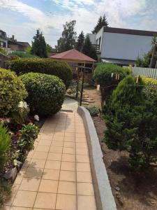 a garden with a brick walkway in a yard at Ferienwohnung Gabry in Saarlouis