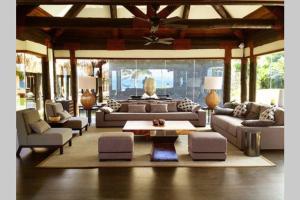 una gran sala de estar con sofás y mesa de centro. en Villa Takali - CFC Certified en Pacific Harbour
