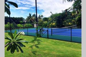 a tennis court with two tennis courts at Villa Takali - CFC Certified in Pacific Harbour