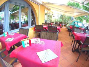 a restaurant with tables with pink tablecloths at Atoll Hotel restaurant in Fréjus