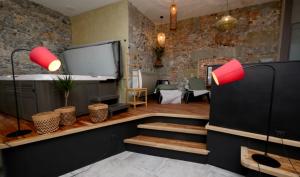 a living room with brick walls and red lamps at Appartement spa privatif Grenoble At Home Spa in Grenoble