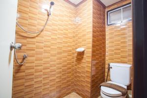 a bathroom with a toilet and a shower at Diana Garden Resort - SHA Extra Plus in Pattaya Central