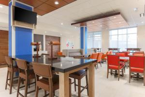 a dining room with a large table and chairs at Holiday Inn Express & Suites Chicago O'Hare Airport, an IHG Hotel in Des Plaines