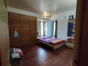 a room with two beds in the corner of a room at Garden Homes 1& 6 in Kolhapur